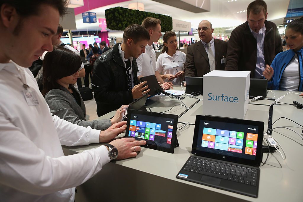 HANOVER, GERMANY - MARCH 05: Visitors try out Windows 8 Surface tablet computers at the Microsoft stand at the 2013 CeBIT technology trade fair on March 5, 2013 in Hanover, Germany. CeBIT will be open March 5-9. (Photo by Sean Gallup/Getty Images)